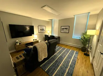 a living room with a couch and a flat screen tv at Crossroads at Park Place in Wilmington