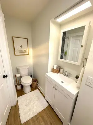 a bathroom with a toilet and a sink and a mirror at Crossroads at Park Place in Wilmington