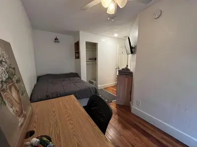 a bedroom with a bed and a table in it at Soothing, Comfy P-Room by Wilson Memorial in Johnson City