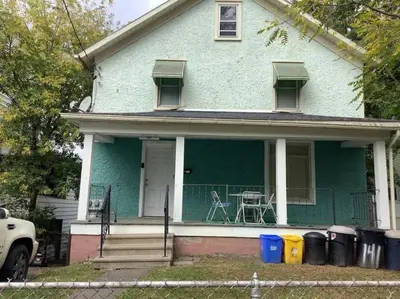 a blue house with a table and chairs on the porch at Soothing, Comfy P-Room by Wilson Memorial in Johnson City