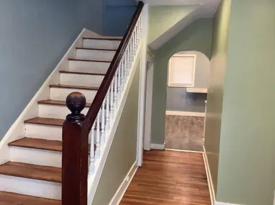a hallway with a staircase with white and wood floors at Inviting, Calming PR -Lourdes Hospital Binghamton in Johnson City
