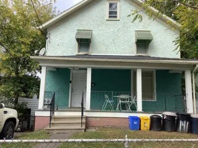 a blue house with a table on the porch at Inviting, Calming PR -Lourdes Hospital Binghamton in Johnson City