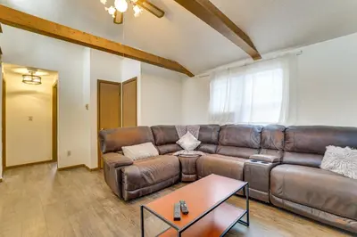 a living room with a leather couch and a table at Ski, Swim and Hike! Family Home in Tobyhanna in Tobyhanna