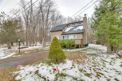 a house with a christmas tree in the snow at Ski, Swim and Hike! Family Home in Tobyhanna in Tobyhanna