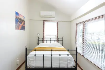 a bedroom with a bed in a room with windows at 1 Bus Stop To NYC Room-Free Parking in Hillside