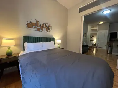 a bedroom with a large bed and a living room at The Marlow Midtown in New York