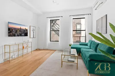 a living room with a green couch at Gorgeous and Fully Equipped Luxury 1 Bedroom Apt in New York