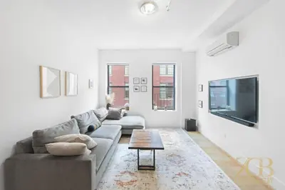 a living room with a couch and a tv at Beautiful and Spacious 2 Bed 2 Bath Apt - Elevator in New York
