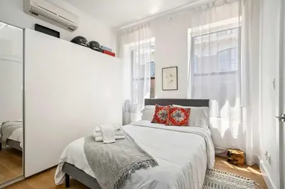 a white bedroom with a bed and a window at Beautiful and Spacious 2 Bed 2 Bath Apt - Elevator in New York