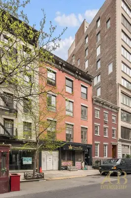 a large brick building on a city street at Sun-Filled Brownstone Apt in Prime Chelsea in New York