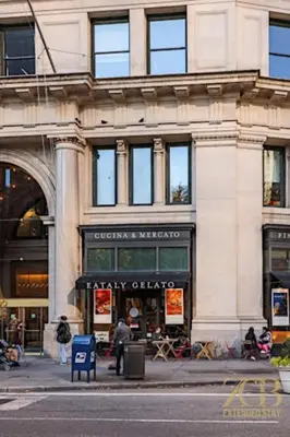a building on a city street with a store at Sun-Filled Brownstone Apt in Prime Chelsea in New York