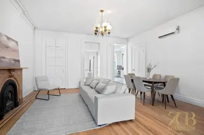 a living room with a couch and a table at Classic NYC Brownstone 2Br Apartment in Prime Chelsea in New York