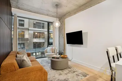 a living room with a couch and a tv at Modern 2BR Terrace WD & Elevator in NoMad in New York