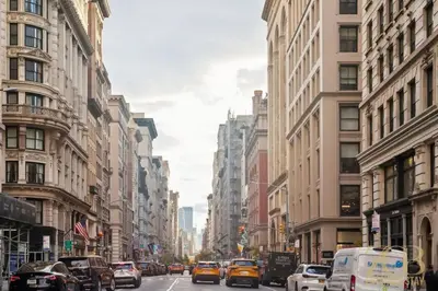 a busy city street filled with cars and buildings at Modern 2BR with WD in Elevator Building in NoMad in New York