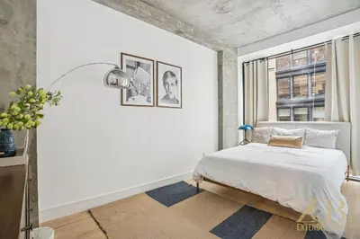 a white bedroom with a bed and a window at Modern 2BR with WD in Elevator Building in NoMad in New York