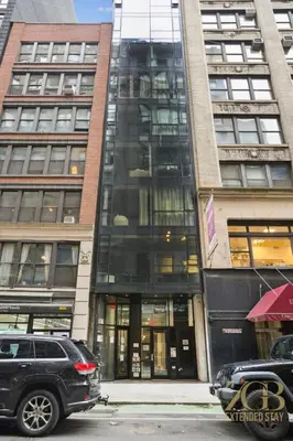 a black suv parked in front of a building at Modern 2BR with WD in Elevator Building in NoMad in New York