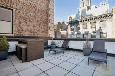 a patio with chairs and a table on a building at Modern 2BR with WD in Elevator Building in NoMad in New York