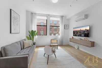 a living room with a couch and a table at Beautifully Renovated 1 bedroom in Prime Manhattan in New York
