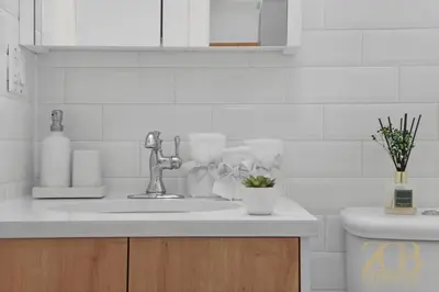 a white kitchen with a sink and a toilet at Beautifully Renovated 1 bedroom in Prime Manhattan in New York