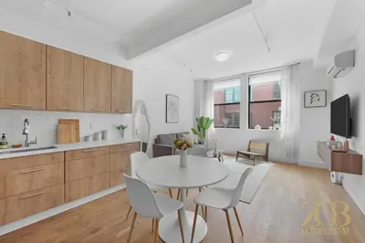 a kitchen and living room with a table and chairs at Beautifully Renovated 1 bedroom in Prime Manhattan in New York
