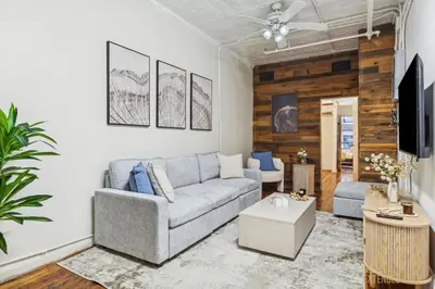 a living room with a couch and a tv at Spacious 3BR Flex 4 with Washer & Dryer in NoMad in New York