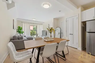 a dining room and living room with a table and chairs at Chic 3BR 2BA West Village Apt with Private Oasis in New York