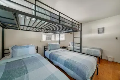 two beds in a room with a loft at Highland Estates, 5 Private Units for 1 Group! in Monticello