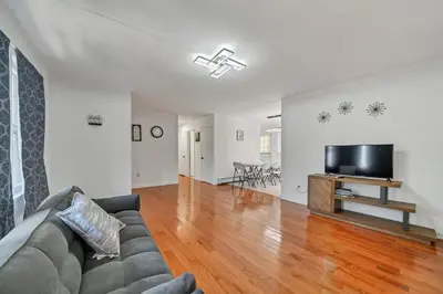 a living room with a couch and a flat screen tv at Highland Estates, 5 Private Units for 1 Group! in Monticello