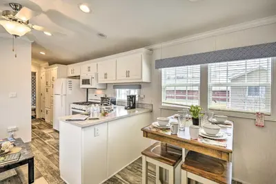 a kitchen with white cabinets and a counter top at Log Cabin And Cottages At Equestrian House in Pleasant Mount