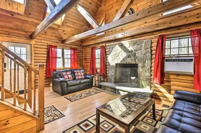 a living room with a fireplace in a log cabin at Log Cabin And Cottages At Equestrian House in Pleasant Mount