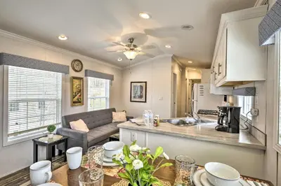 a kitchen and living room with a couch and a table at Log Cabin And Cottages At Equestrian House in Pleasant Mount