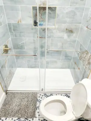 a bathroom with a toilet and a shower at Cozy 2BR in Newark for Families, Work & Long Stays in Newark