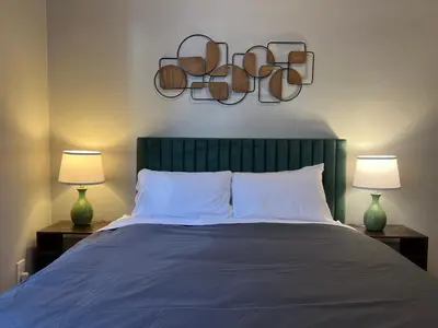 a bedroom with a large bed with two lamps at Cortland Manhattan Suites in New York