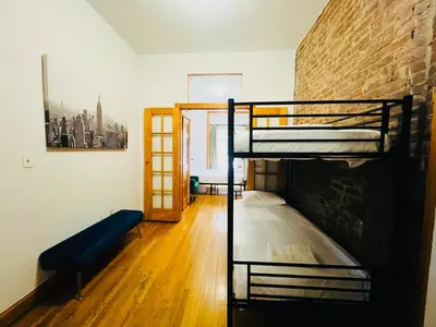 a room with two bunk beds and a brick wall at The Kensington on 44th in New York
