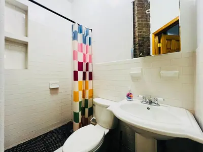 a bathroom with a toilet and a sink at The Kensington on 44th in New York