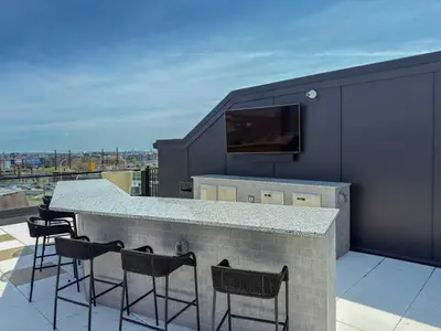 a bar on the roof of a building at Luxury Stay Near NYC | Full Access to Amenities in Newark
