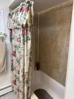 a shower curtain in a bathroom next to a tub at Cozy room with Queen bed 20 min to NYC in Ridgefield Park