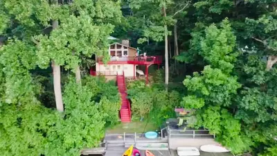 an aerial view of a house in the woods at Villa Adriana 4bdr 2 bath lake front dream home in Vernon