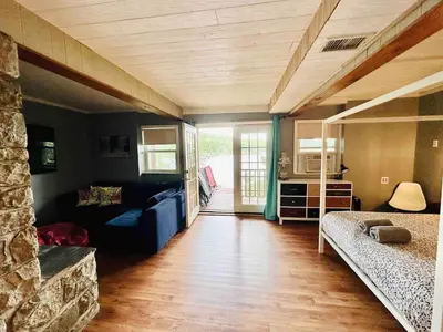 a bedroom with a bed and a couch in a room at Villa Adriana 4bdr 2 bath lake front dream home in Vernon