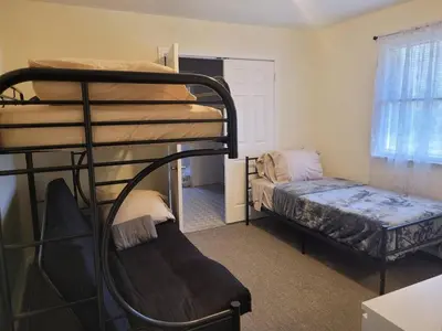 a bedroom with two bunk beds and a bed at Cozy 4 Bedrooms Pool Game Room in Tobyhanna