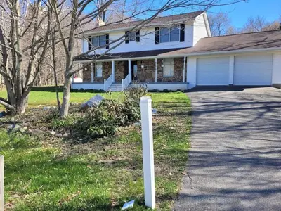 a white post in front of a house at Cozy 4 Bedrooms Pool Game Room in Tobyhanna