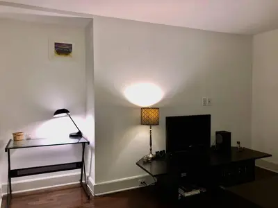 a living room with a table and a lamp at Fantastic updated apartment with parking in Glenside