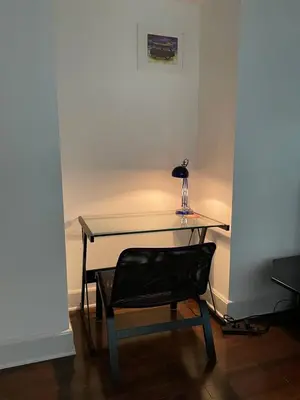 a desk with a chair and a table with a lamp at Fantastic updated apartment with parking in Glenside