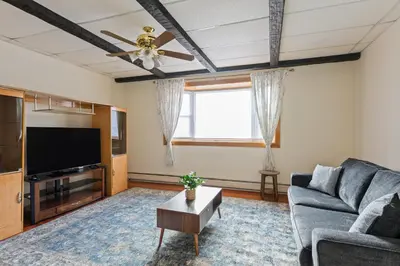 a living room with a couch and a flat screen tv at All-American classic,18 min to Manhattan in Carlstadt