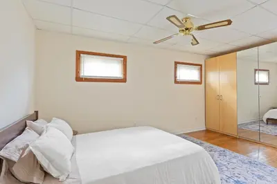 a bedroom with a bed and a ceiling fan at All-American classic,18 min to Manhattan in Carlstadt