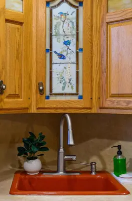 a kitchen sink with a glass window above it at All-American classic,18 min to Manhattan in Carlstadt