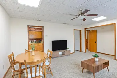 a living room with a table and a flat screen tv at Classic American-style, 18 min to NYC in Carlstadt