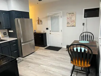 a kitchen with a refrigerator and a table and chairs at Cozy Studio Apartment in Montgomery