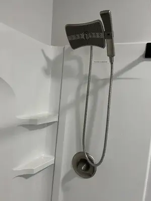 a shower in a white room with a toilet at Cozy Studio Apartment in Montgomery