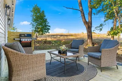 a patio with chairs and a table and a grill at Pond Haven Retreat Wood-Burning HotTub & FirePit in Mount Bethel